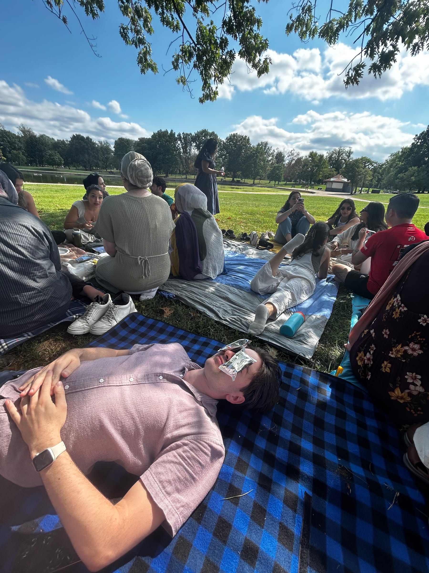 Friends relaxing on picnic blankets in a park