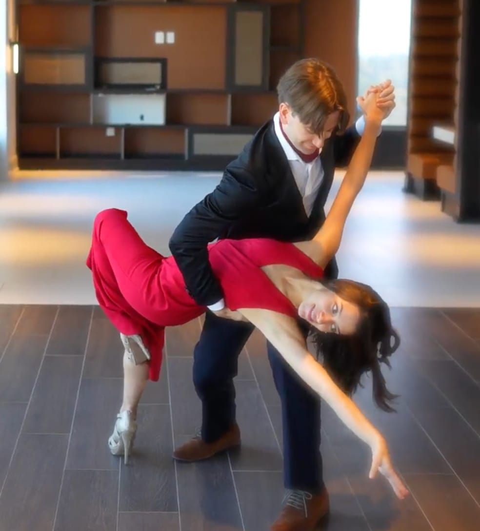 Andre dipping his partner in a ballroom dance