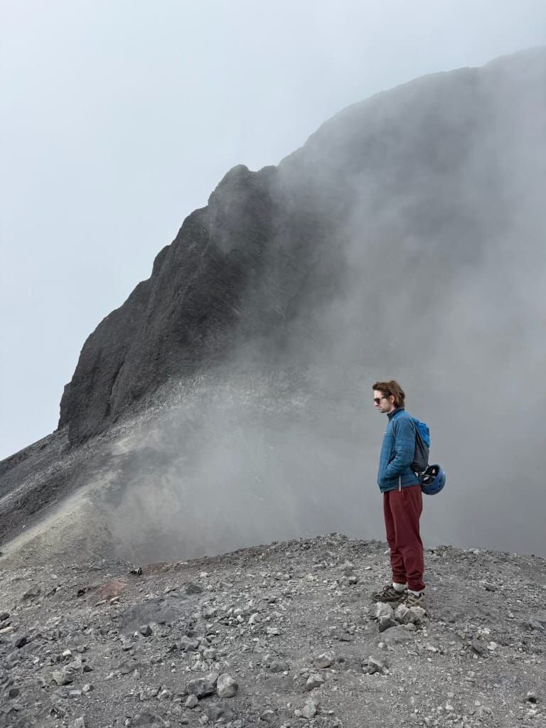 Andre on a rocky mountain ridge in the mist
