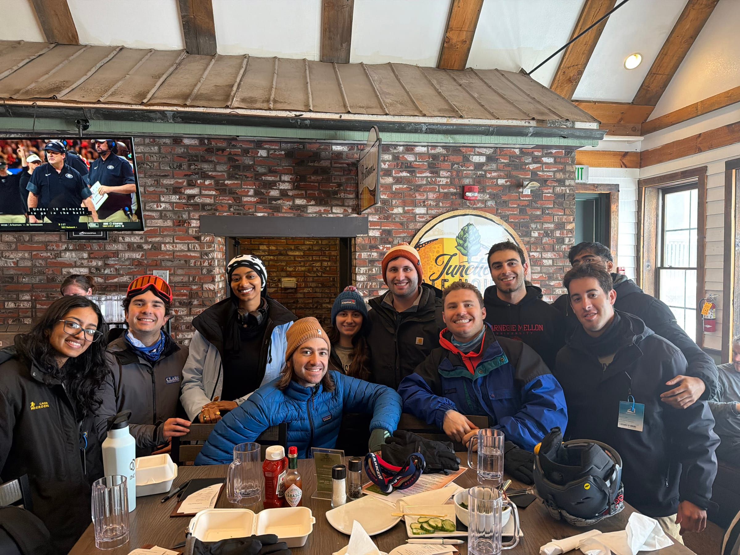A group of friends around a table in a ski lodge